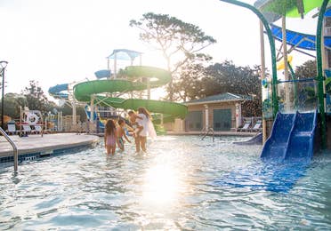 Family walking towards Splash Cove waterslide at South Beach Resort in Myrtle Beach, South Carolina.