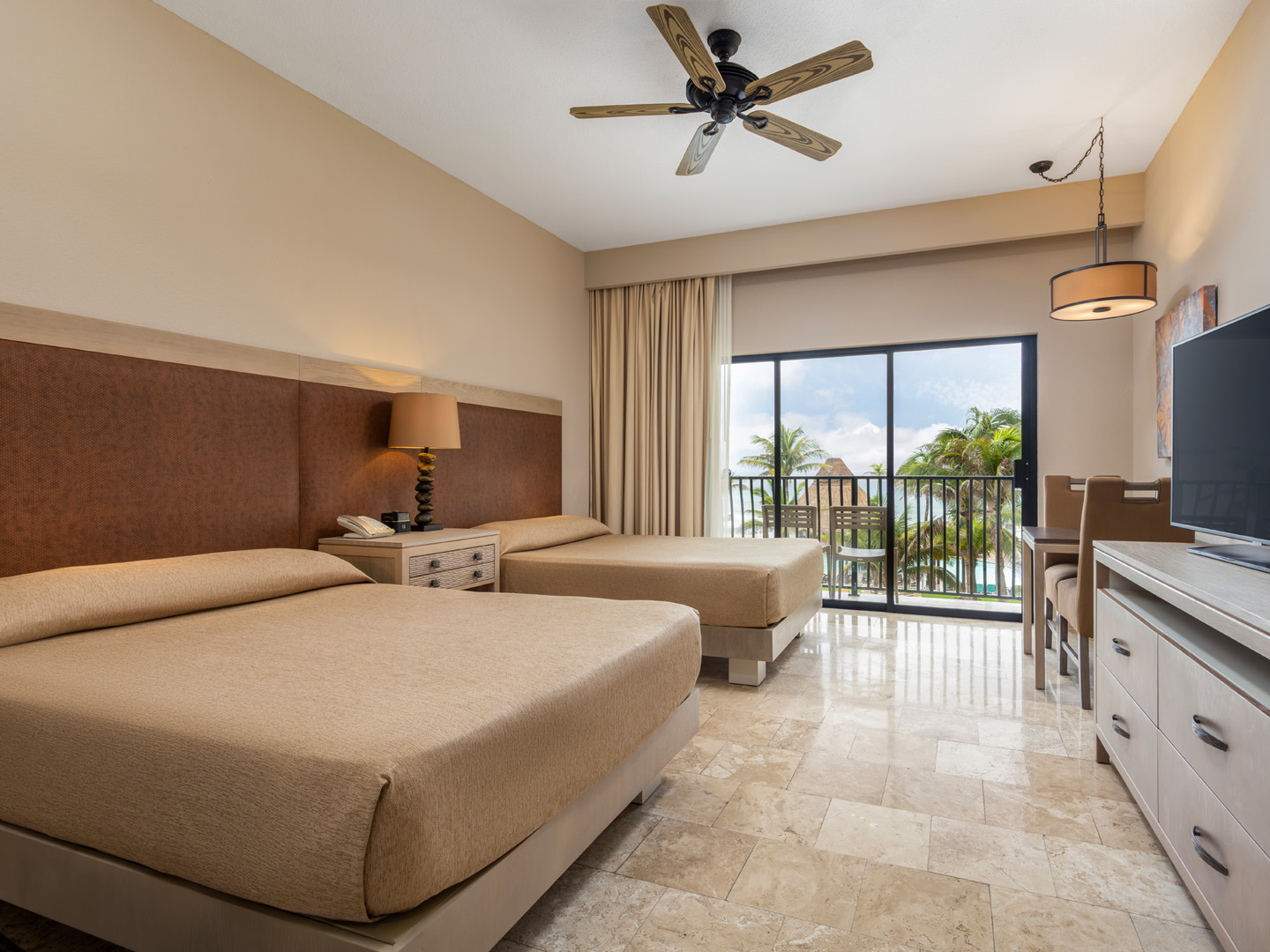 Oceanview guestroom with two beds and a private balcony.