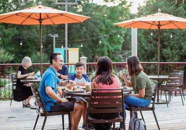 Family eating on outdoor patio at Grill at Villages Resort in Flint, Texas.