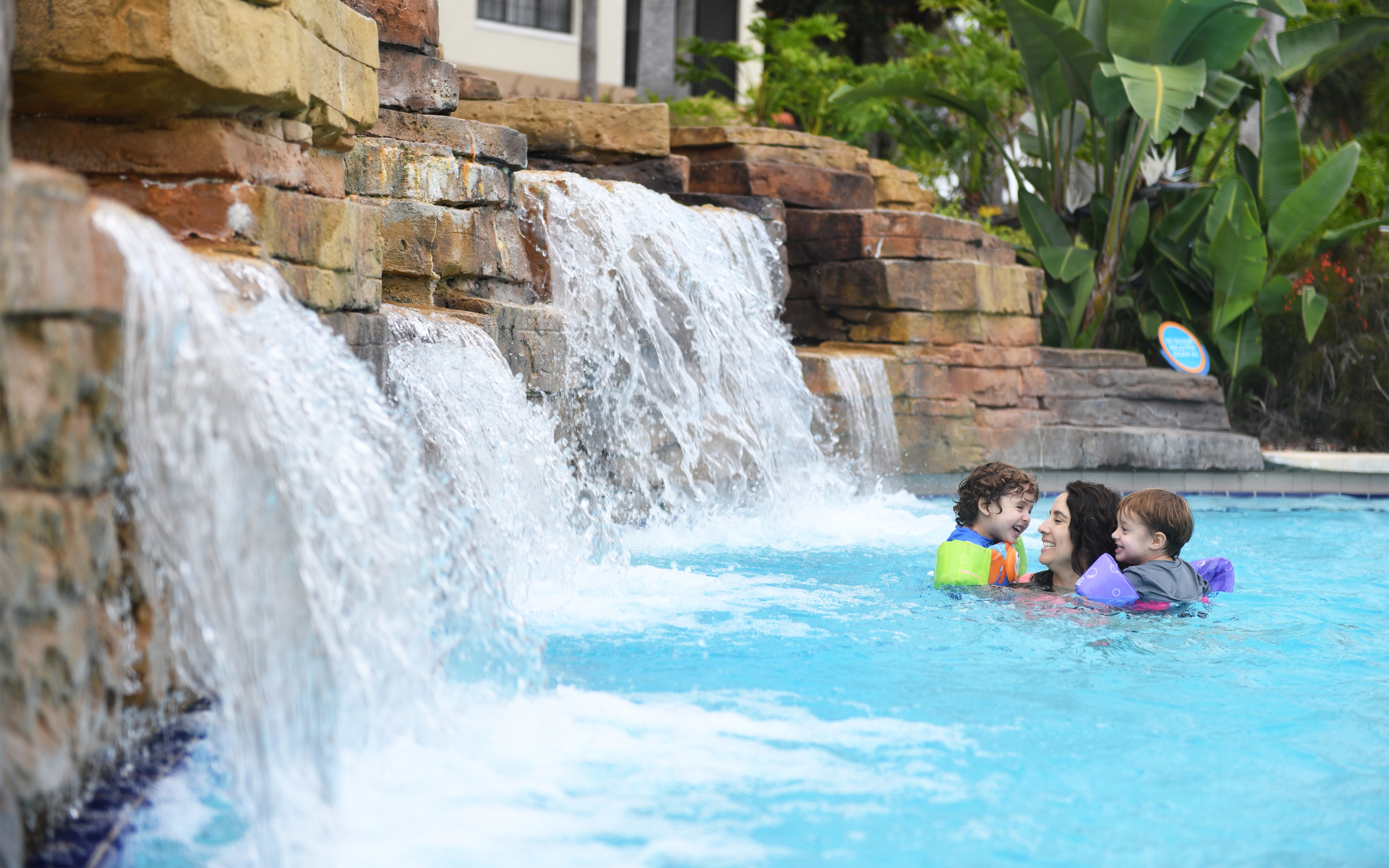 Adult and two children enjoying lazy river at Orange Lake Resort.