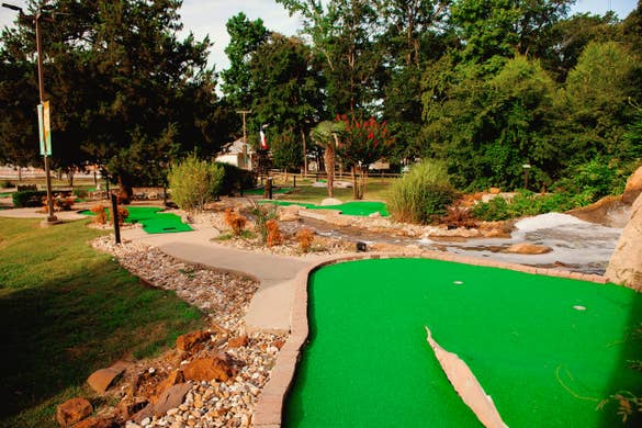 A waterfall feature and various putting greens at our mini golf course at Villages Resort in Flint, Texas.