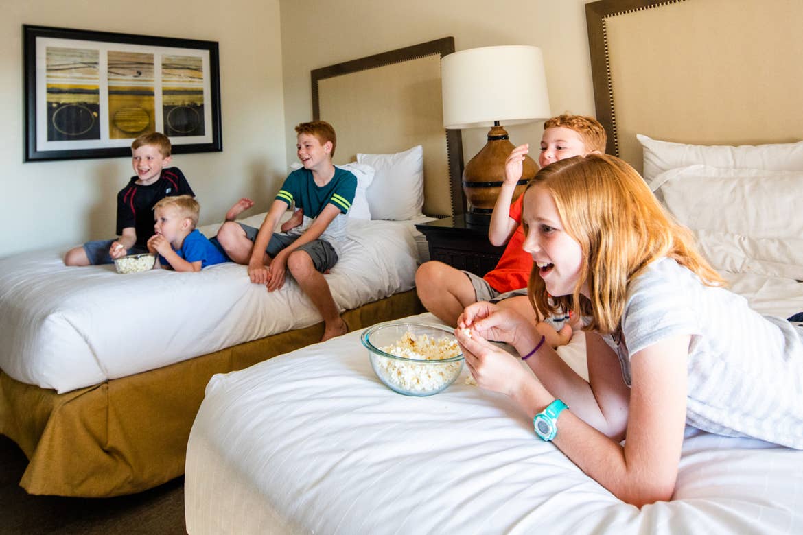 The Averett family enjoys downtime on two beds in our villa at Scottsdale Resort.