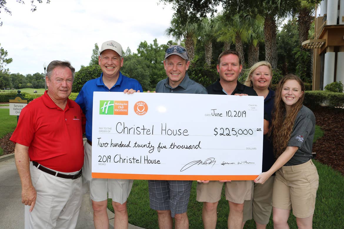 HICV President, Tom Nelson (middle) holds a Charitable Donation Check with representatives of Christel House.