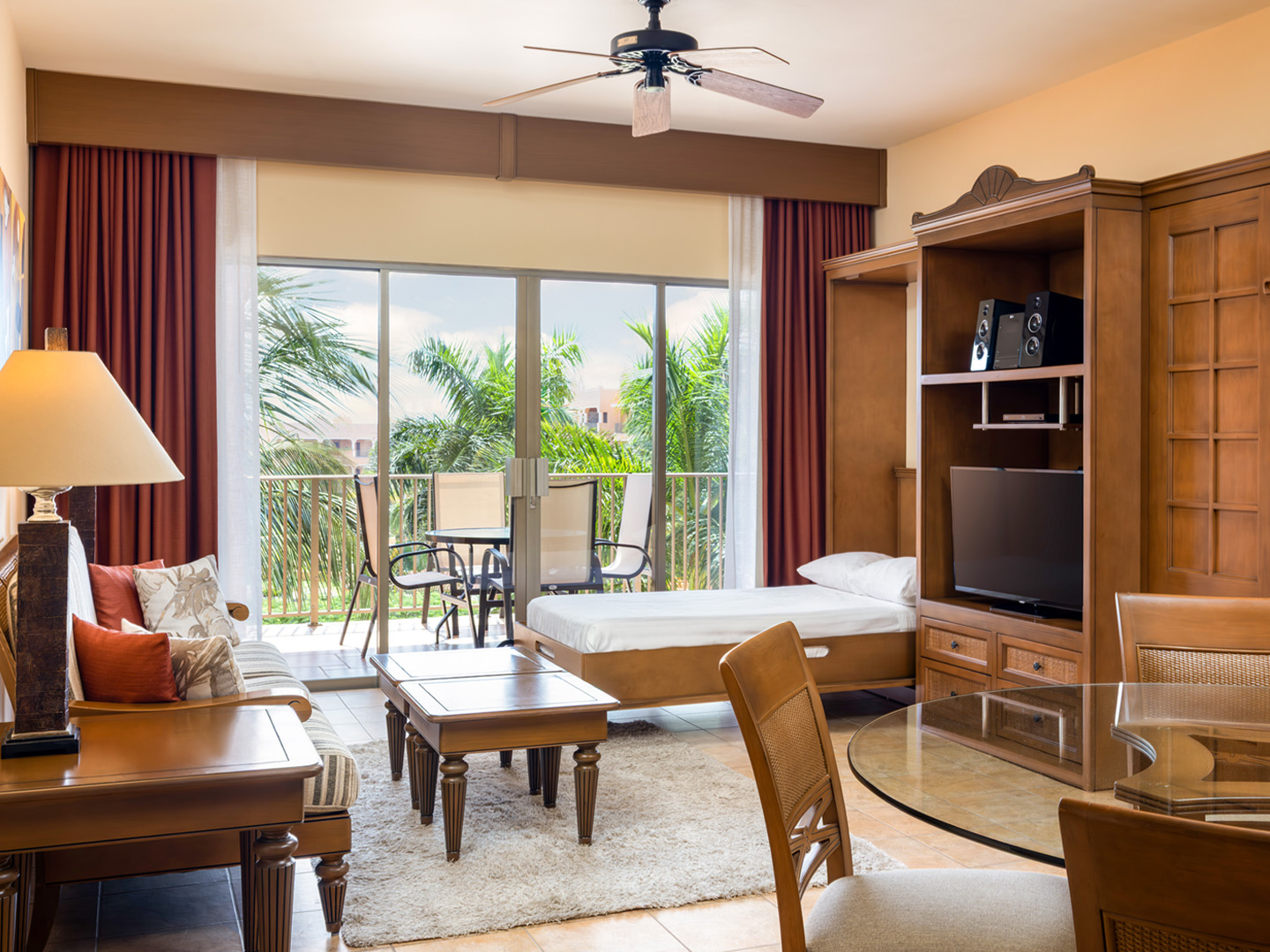 Spacious living room with Murphy bed and balcony access.