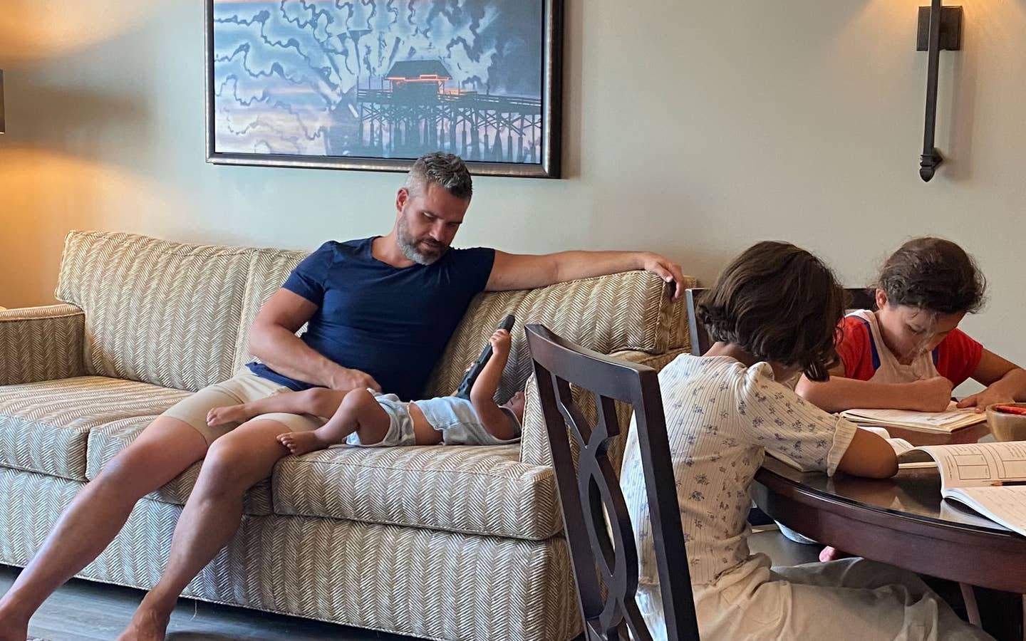 Brenda's family sits in their villa with work and play.