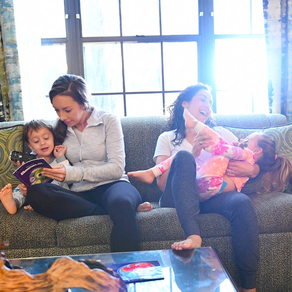 Family reading and laughing on a sofa