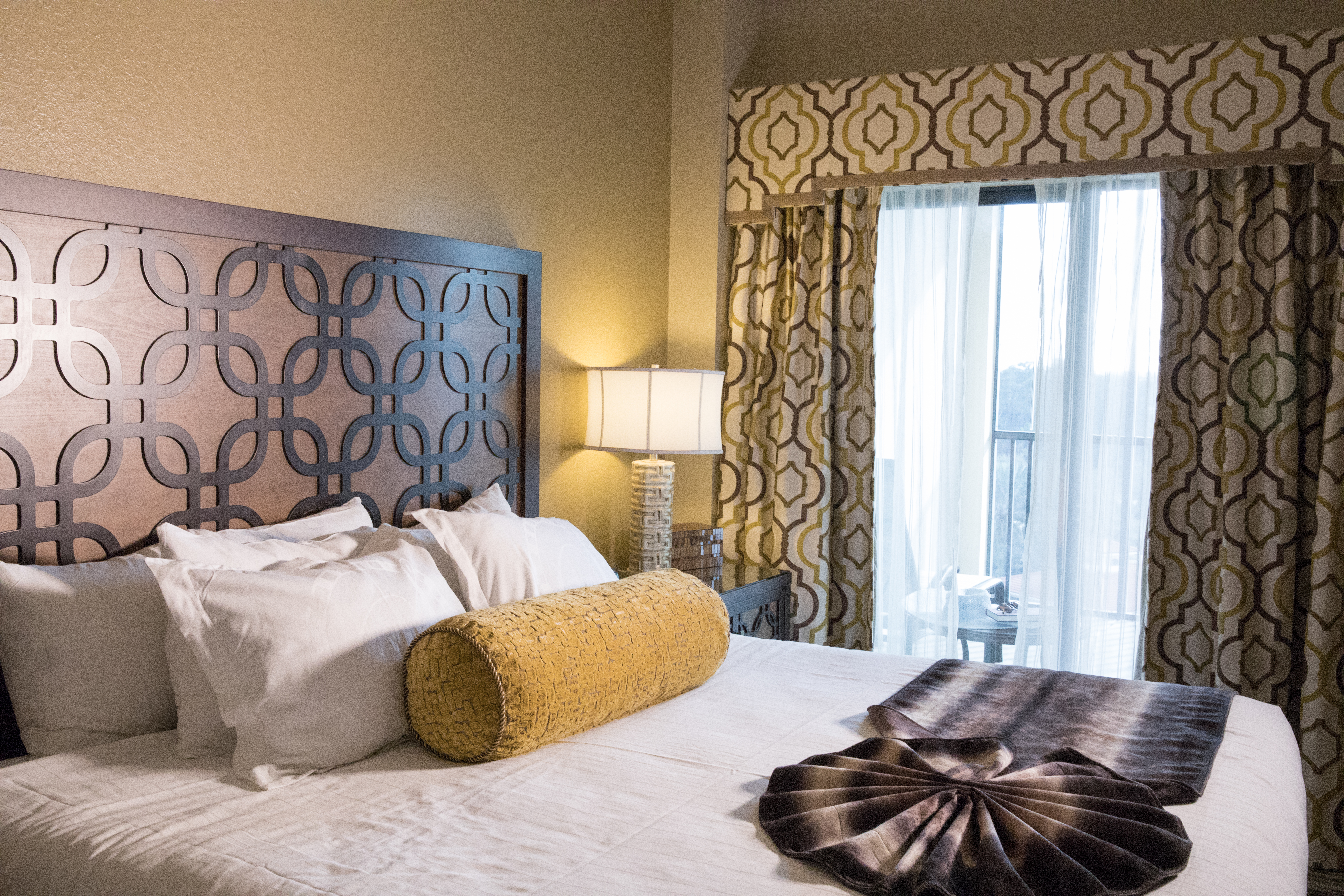 Closeup of bed and large window in a Signature villa in River Island at Orange Lake Resort near Orlando, Florida