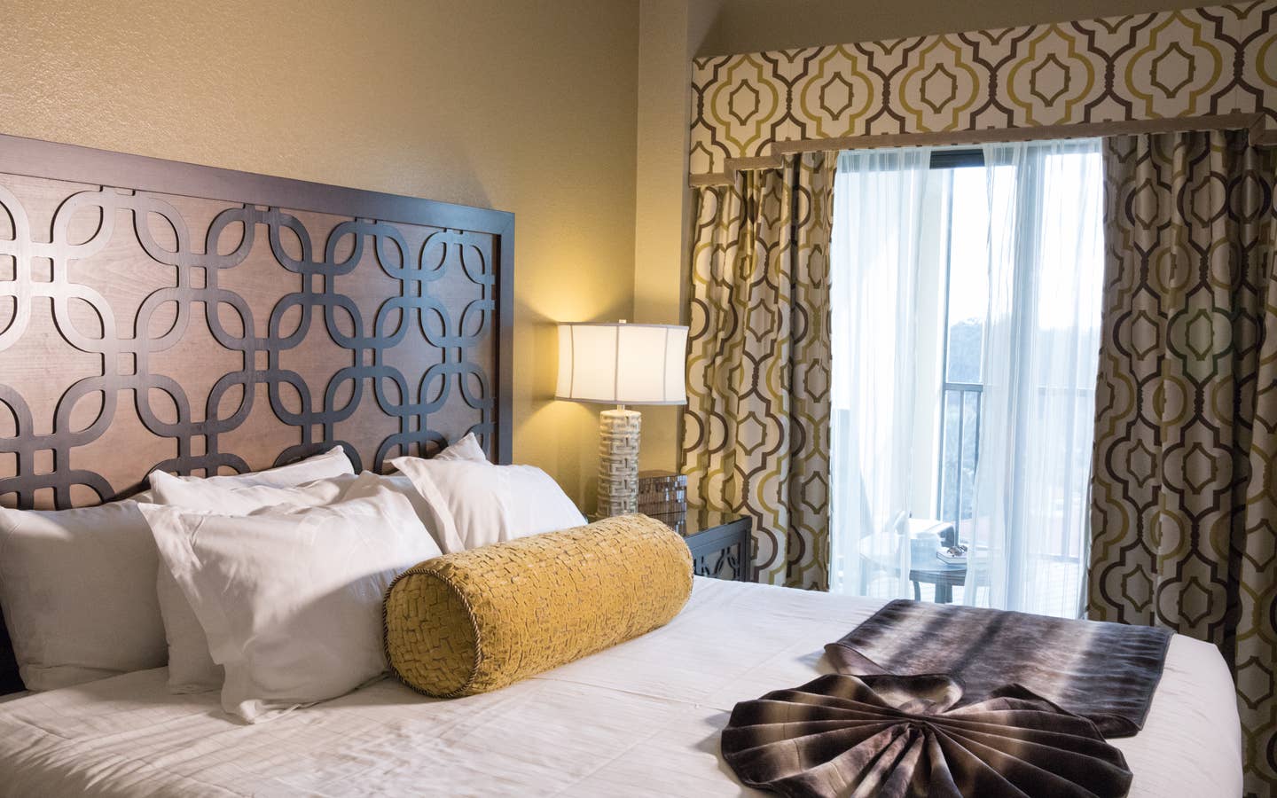 Closeup of bed and large window in a Signature villa in River Island at Orange Lake Resort near Orlando, Florida