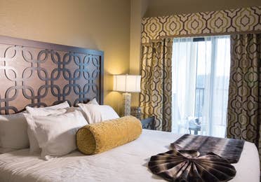 Closeup of bed and large window in a Signature villa in River Island at Orange Lake Resort near Orlando, Florida