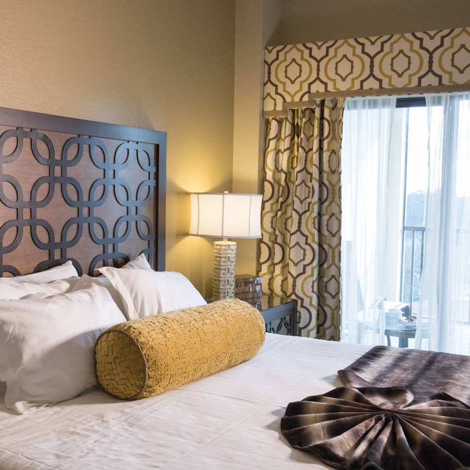 Closeup of bed and large window in a Signature villa in River Island at Orange Lake Resort near Orlando, Florida