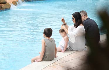Family sitting near the pool at Orange Lake Resort in Orlando, FL