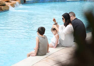 Family sitting near the pool at Orange Lake Resort in Orlando, FL