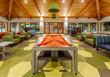Large indoor area with pool table, table tennis, television and plenty of comfortable seating in Scottsdale Resort in Arizona.