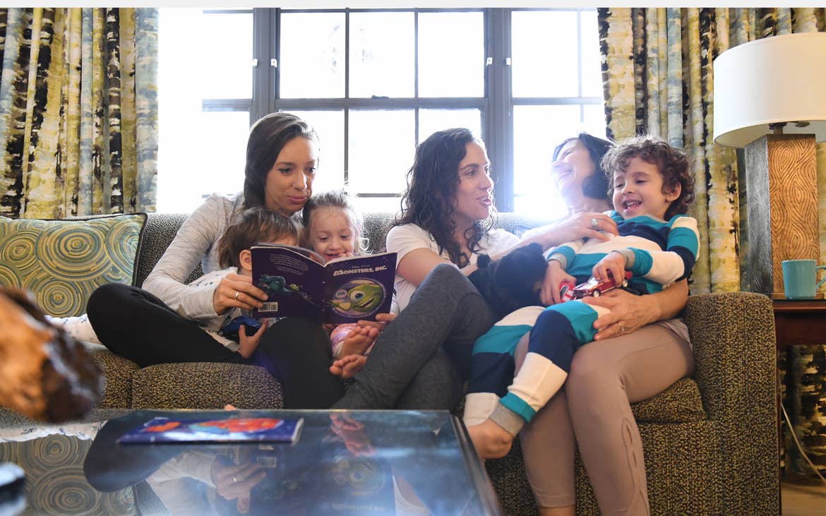 Family sitting on a couch in a villa at Orange Lake Resort
