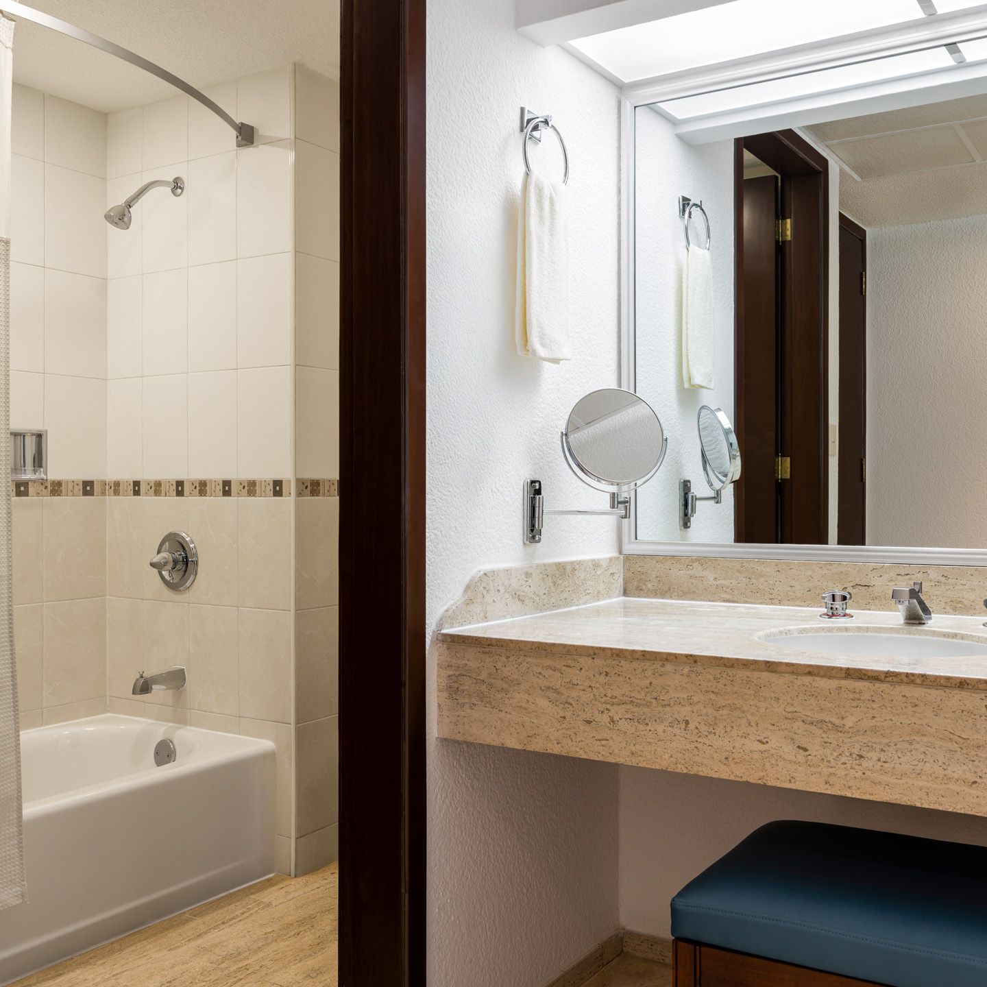 Villa living room with ocean-view balcony, sofa, and dining area.