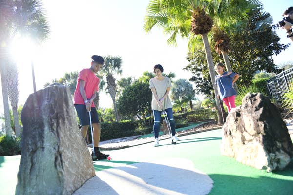 Family enjoying mini golf at Orange Lake Resort near Orlando, Florida