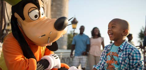Child at Disney's Magic Kingdom interacting with Goofy near Orange Lake Resort