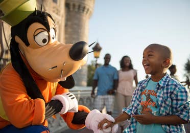 Child at Disney's Magic Kingdom interacting with Goofy near Orange Lake Resort