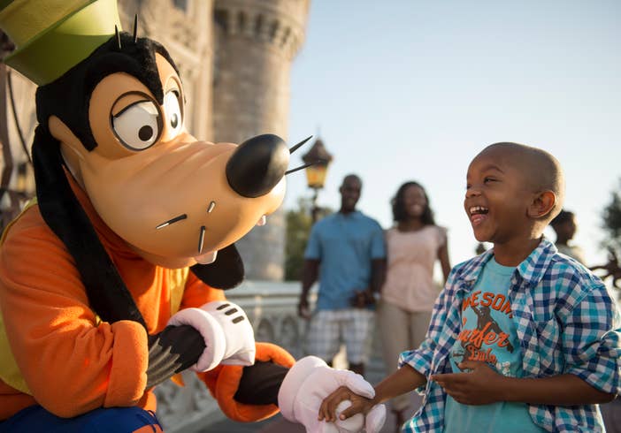 Child at Disney's Magic Kingdom interacting with Goofy near Orange Lake Resort
