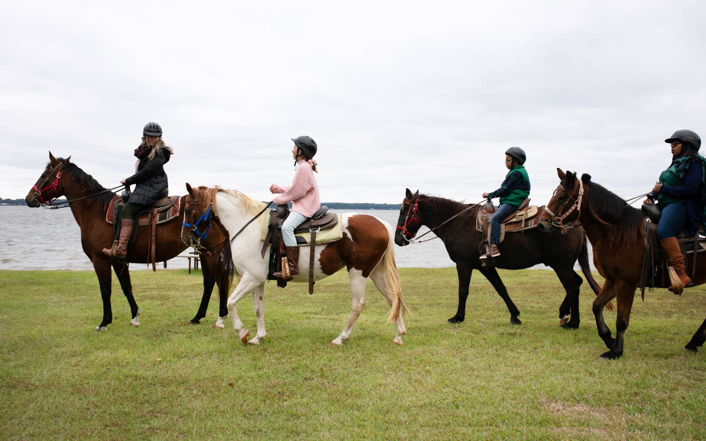 Group of three people riding horses at Villages Resort in Flint, Texas.