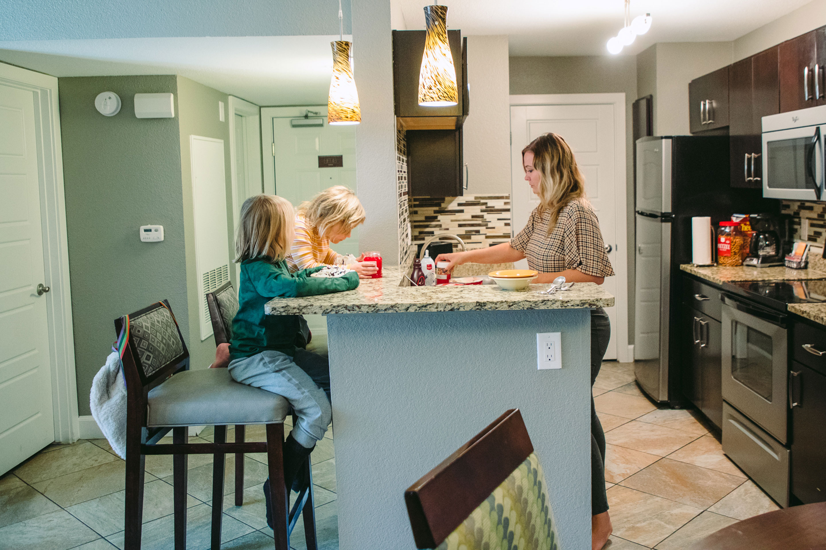 The Haby kids add ice cream toppings in the kitchen of their Signature Collection villa at our Desert Club Resort located in Las Vegas, Nevada.