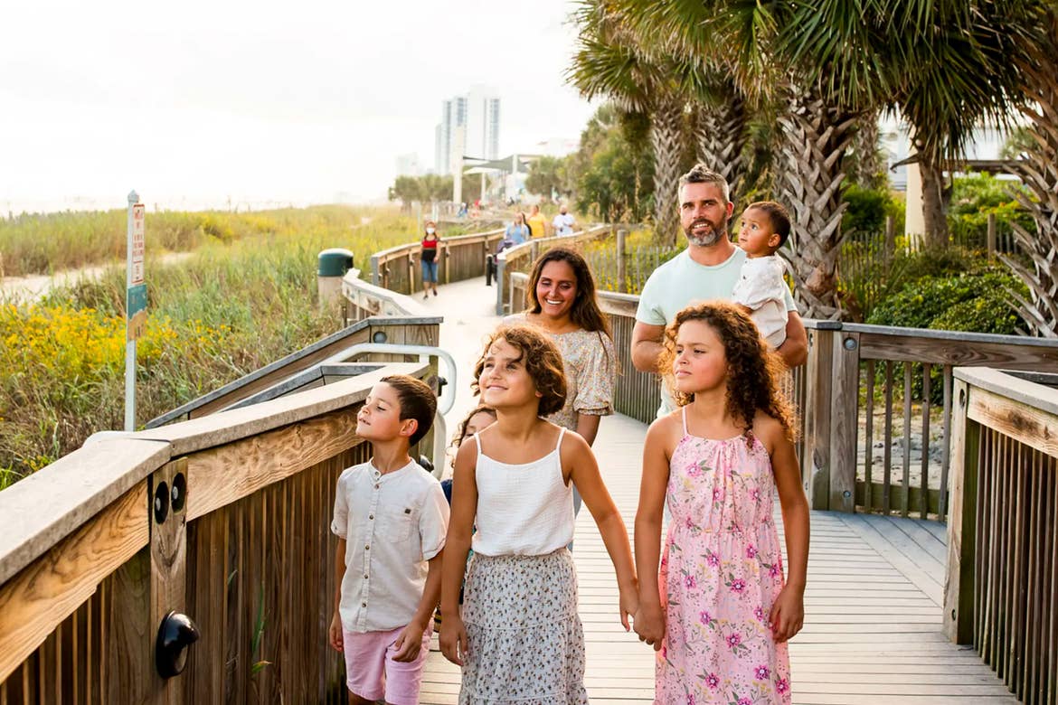 Author, Brenda Rivera Stearns' family walks along the boardwalk near our South Beach Resort in Myrtle Beach, South Carolina.