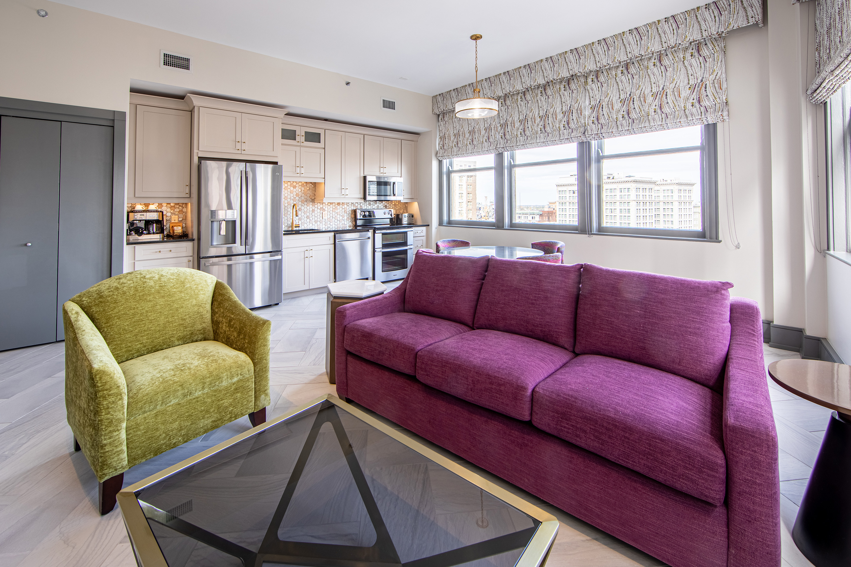 Living room and kitchen in a one-bedroom Signature Collection villa at New Orleans Resort in Louisiana.