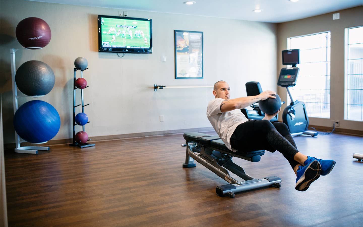 Man working out with weight ball in fitness center at Desert Club Resort in Las Vegas, Nevada.