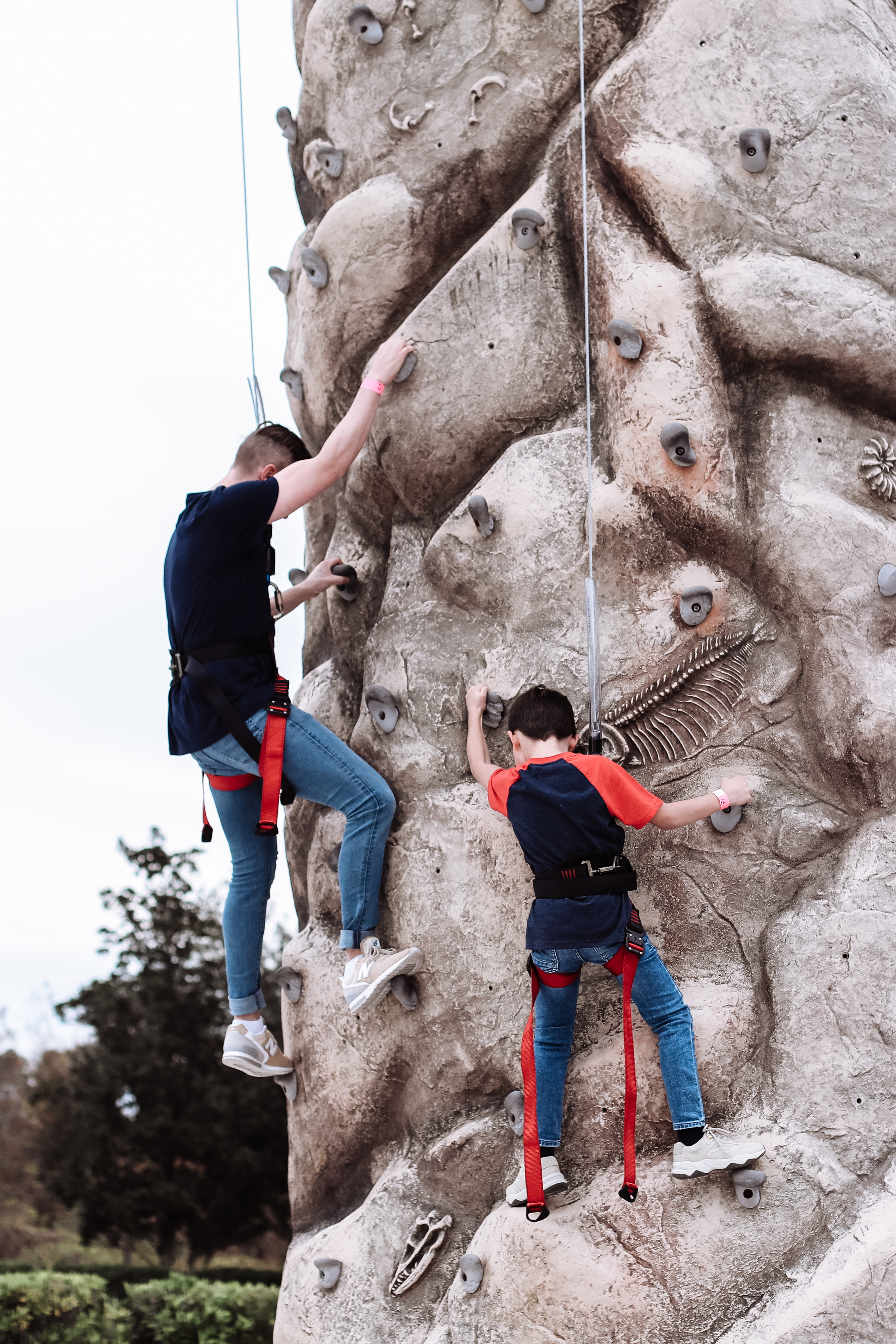 Mia's husband and son climbing a rock wall