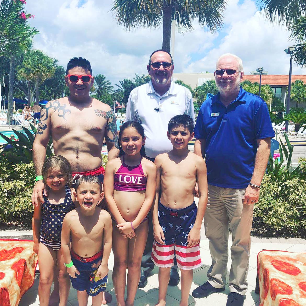 Featured Member, Sara Perez's family stands with HICV Team Members outside of our River Island pool.