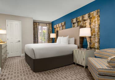 Bright, modern bedroom with bold hues and cozy seating.