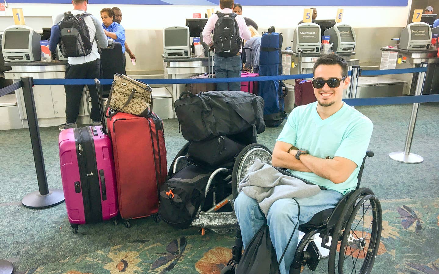 Danny at the airport next to all his luggage