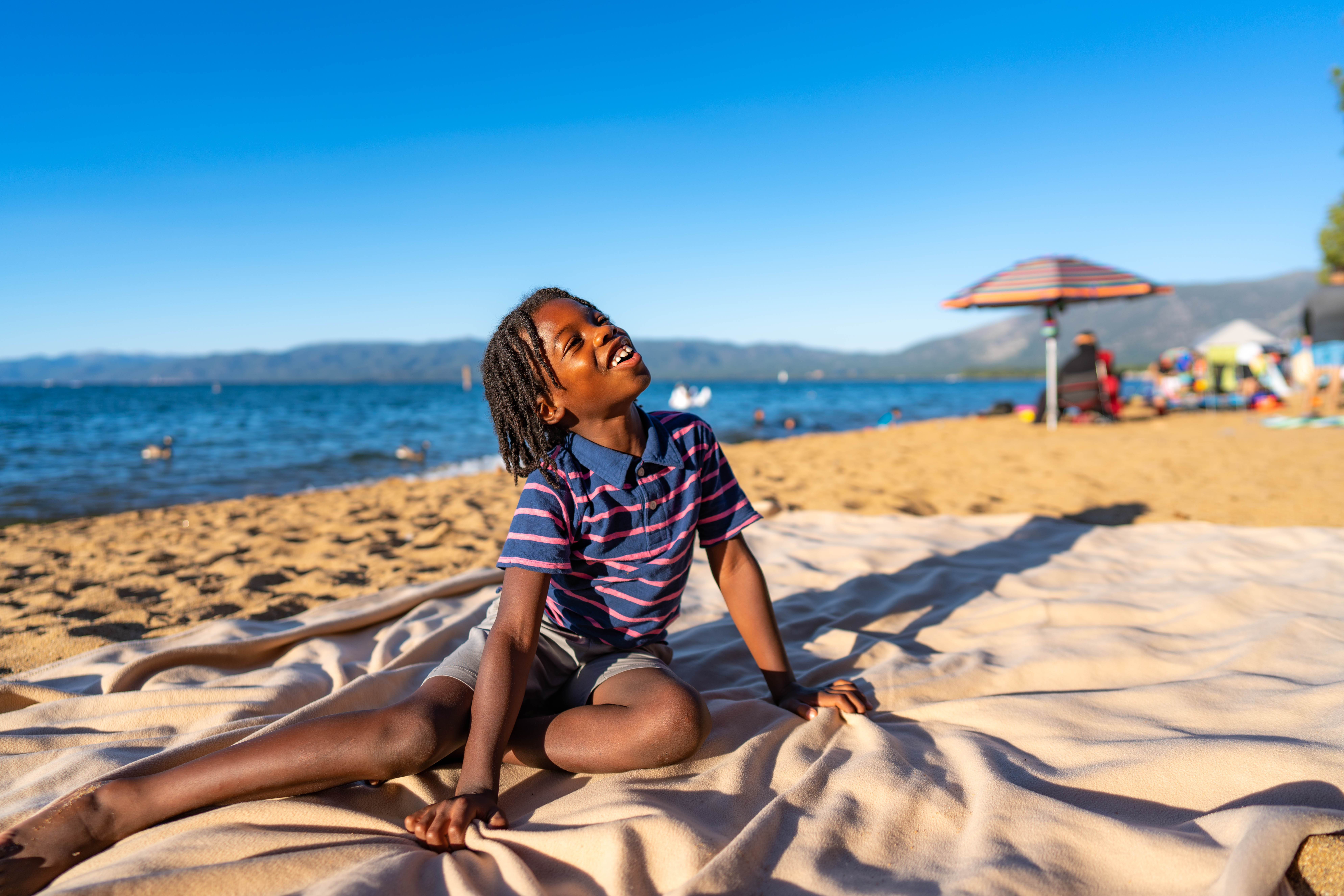 Karen’s son, Aiden, sitting on a blanket at Pope Beach