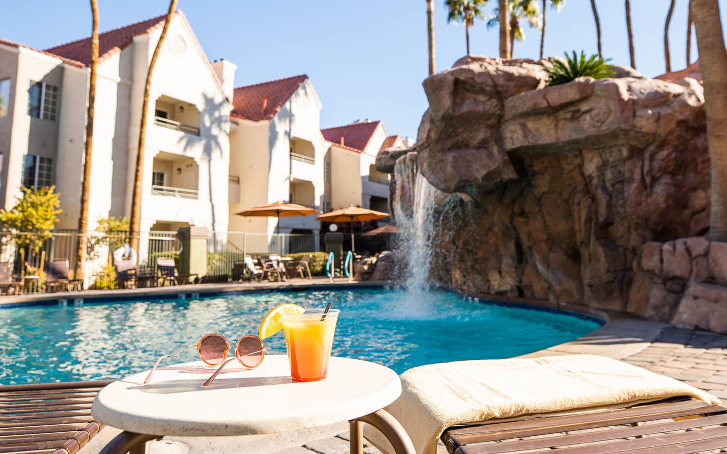 Drinks by waterfall pool at Desert Club Resort in Las Vegas, Nevada.