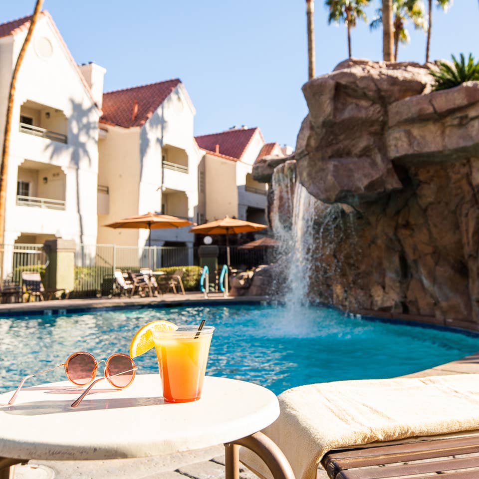 Drinks by waterfall pool at Desert Club Resort in Las Vegas, Nevada.