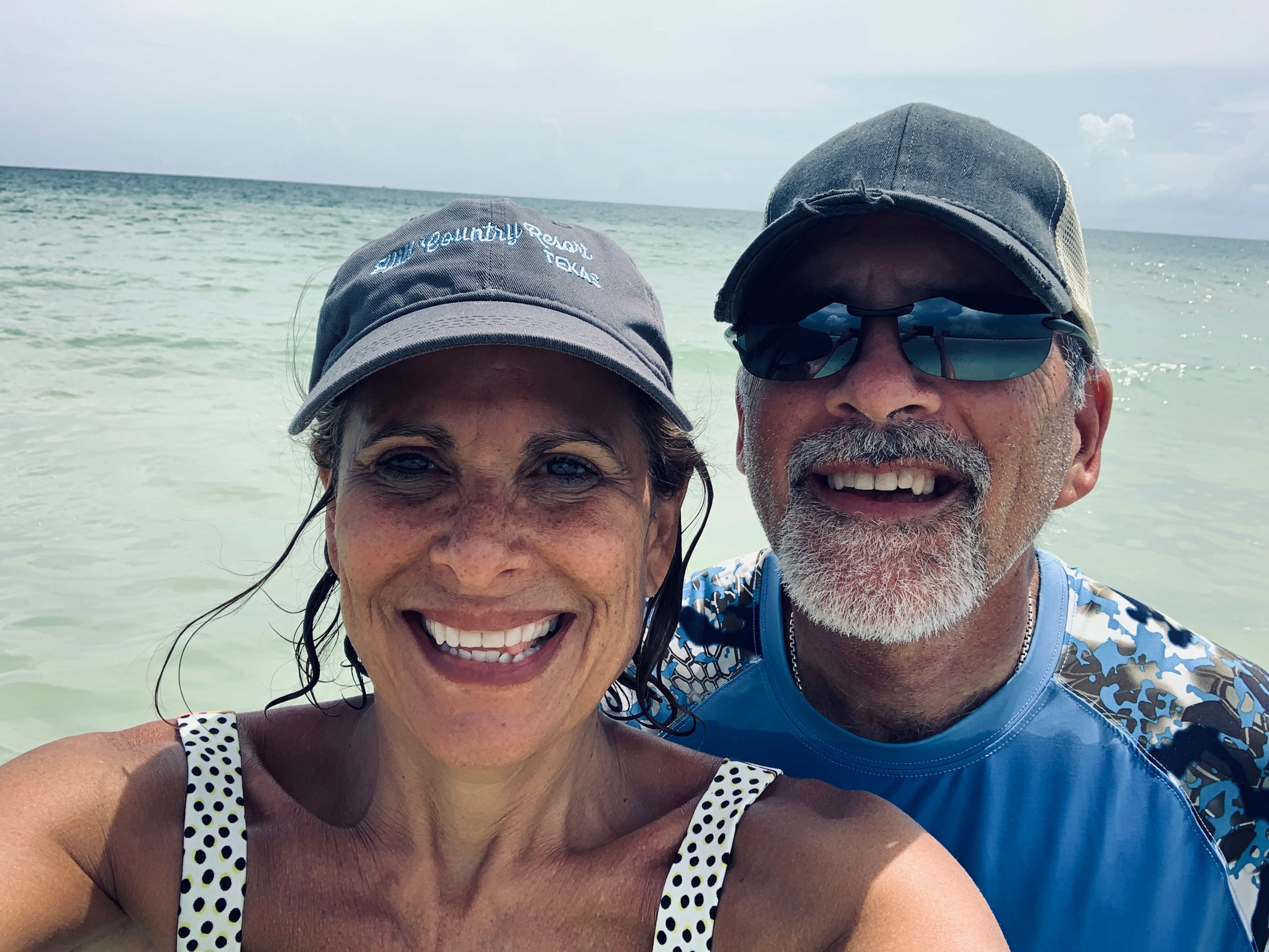 Beach selfie of Denise and CJ with the ocean in the background.