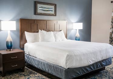 Bedroom with bed and two nightstands in a two-bedroom villa at Cape Canaveral Beach Resort.