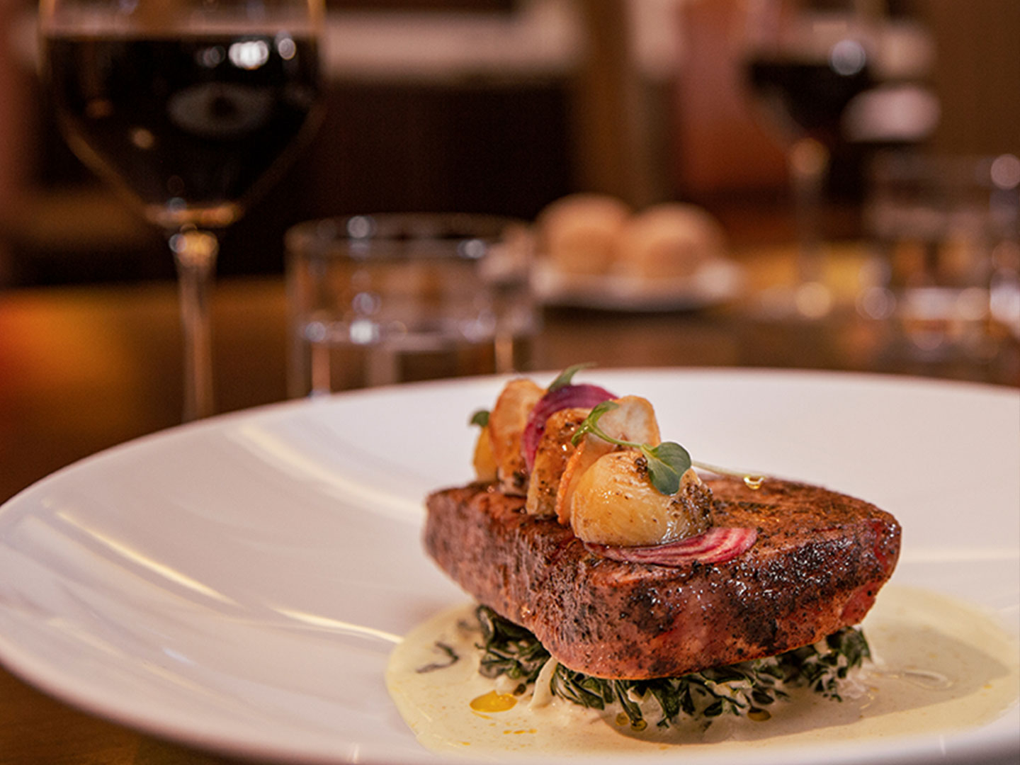 At the Los Murales, a dinner plate with blackened fish on top of creamed greens, topped with sauteed onions and potatoes at the Royal Haciendas, Playa del Carmen, Mexico