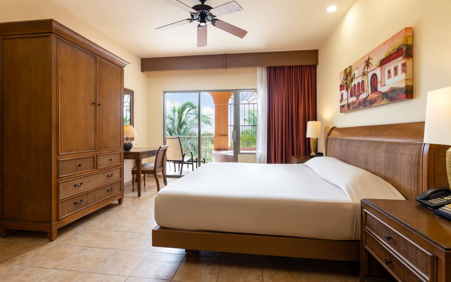 Large garden-view bedroom opening to a balcony with soaking tub.