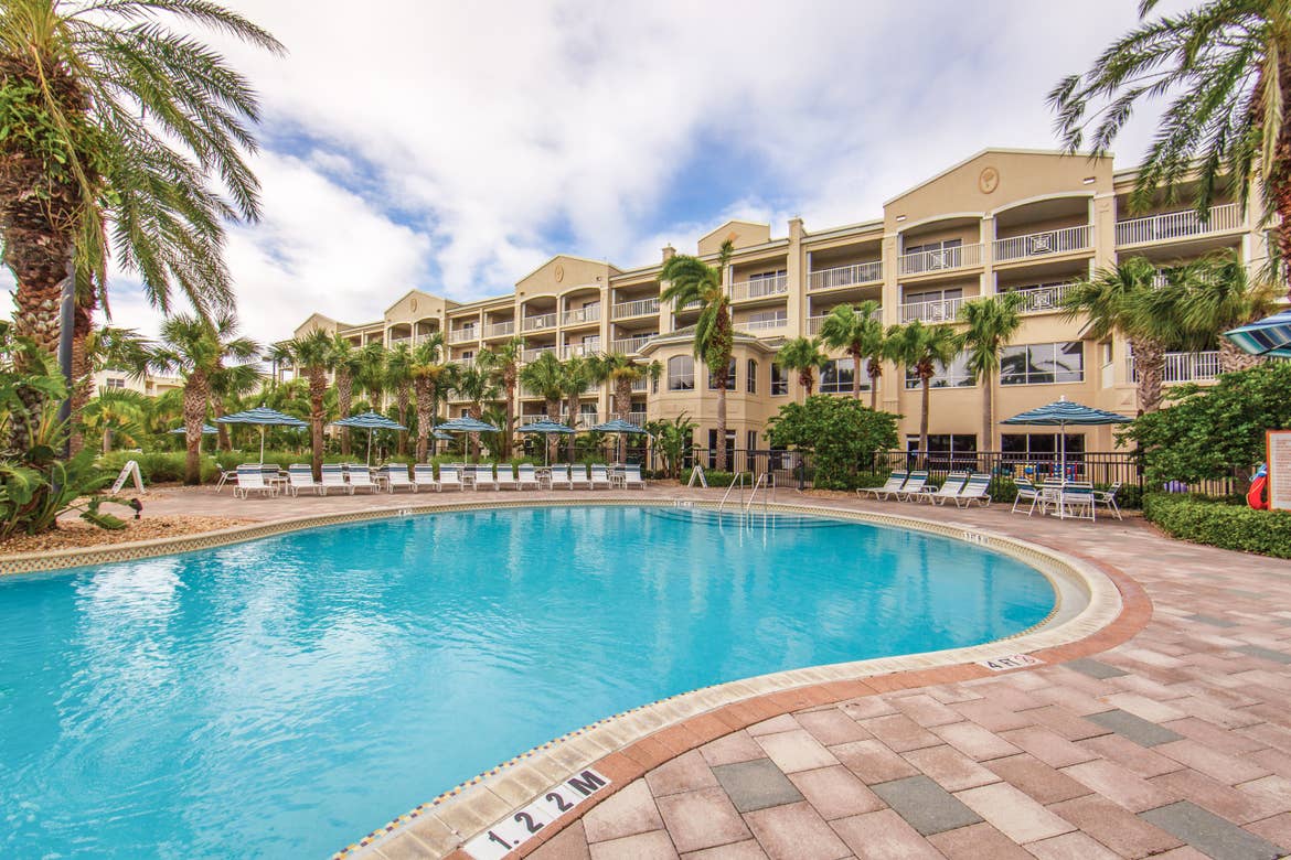 Outdoor pool surrounded by palm trees at Cape Canaveral Beach Resort