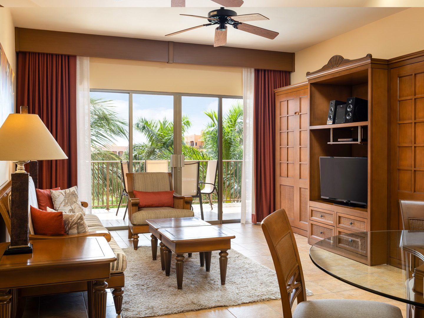 Spacious living room with balcony access and warm décor.