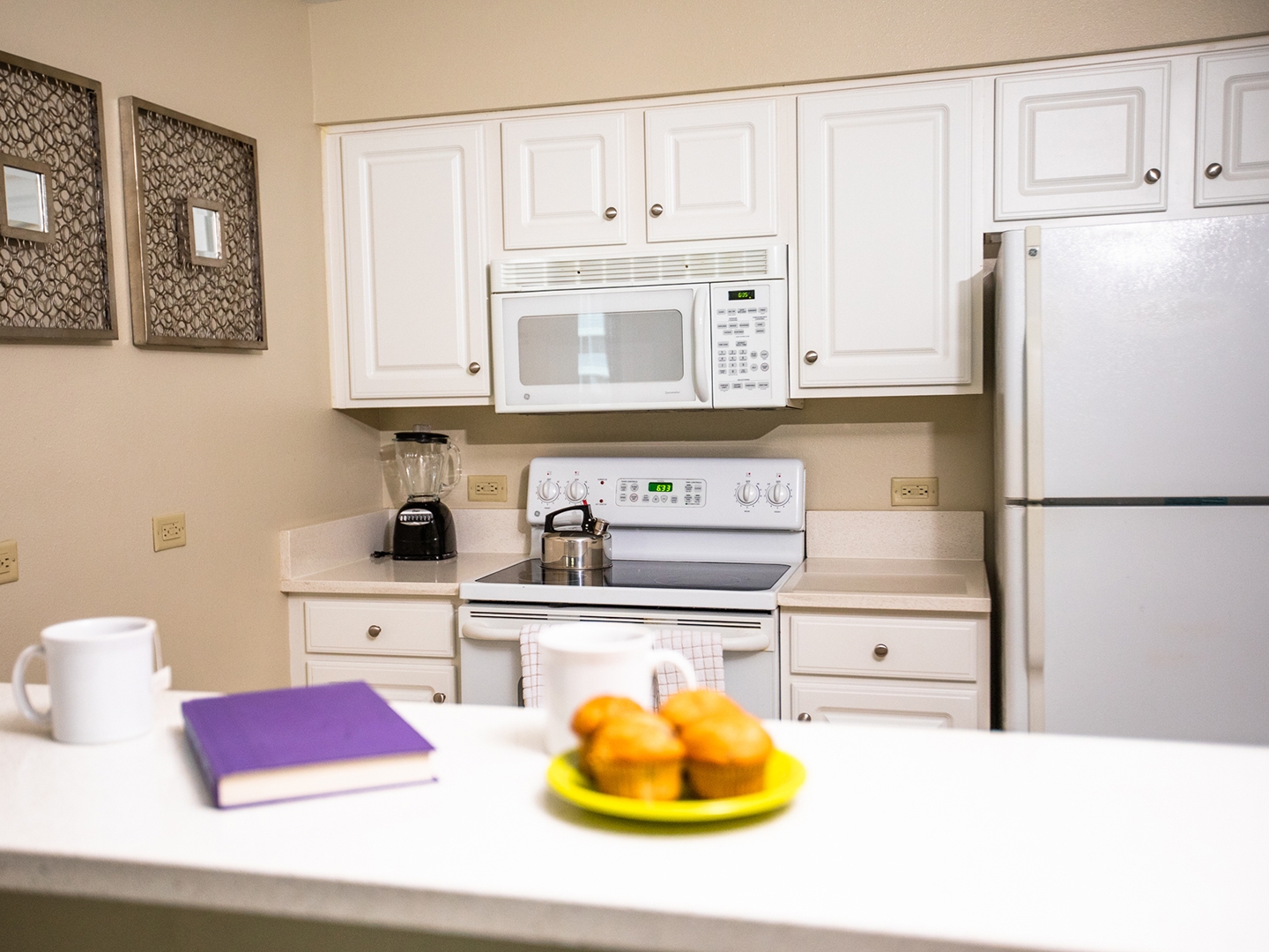 Full kitchen with stove, microwave and fridge in a two-bedroom villa at South Beach Resort in Myrtle Beach, South Carolina.
