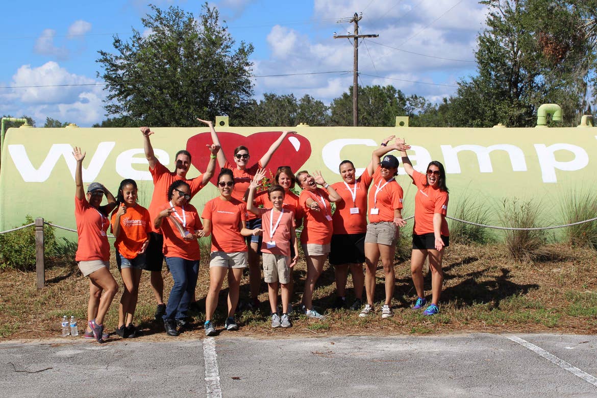 HICV Volunteers in front of a 'We Love Camp!' tank at easterseals.