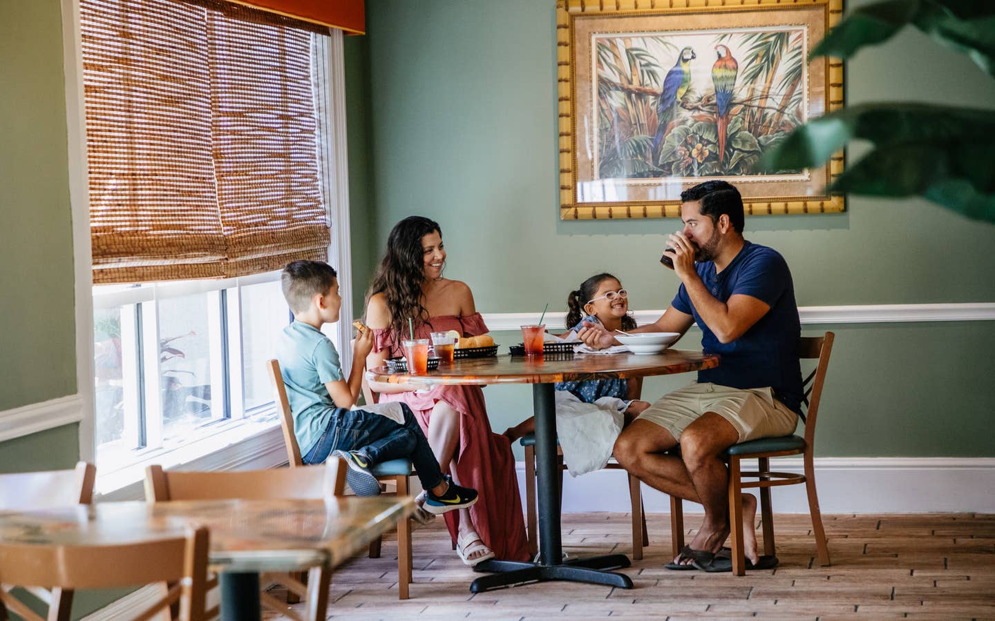Family of four eating at Cape Grill & Bar at Cape Canaveral Beach Resort in Florida.
