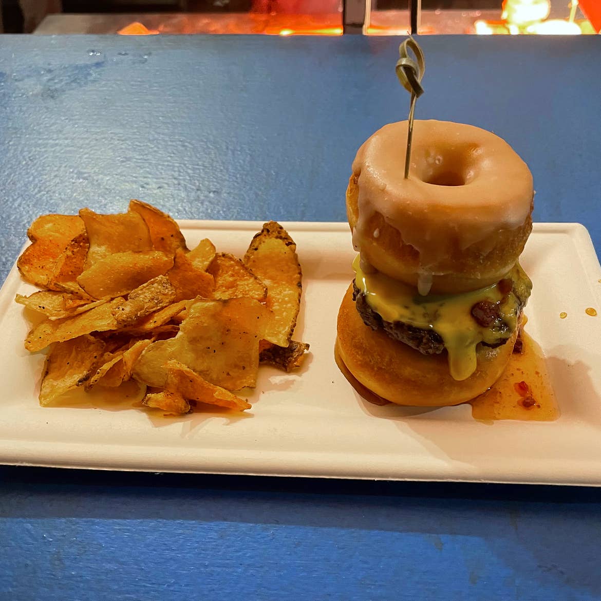 A doughnut slider with kettle chips.