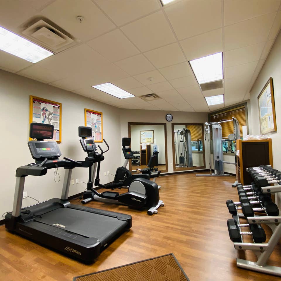 Fitness center with a treadmill, stationary bicycle, elliptical and free weights at Smoky Mountain Resort in Gatlinburg, Tennessee.