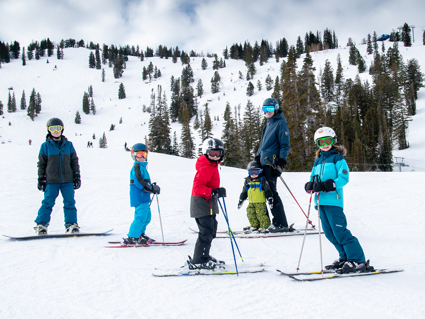 Featured Contributor, Jessica Averett's family, adorn with ski gear, make their way down the snowy slopes.