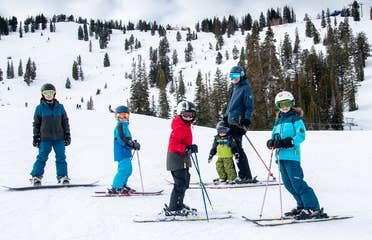 Featured Contributor, Jessica Averett's family, adorn with ski gear, make their way down the snowy slopes.