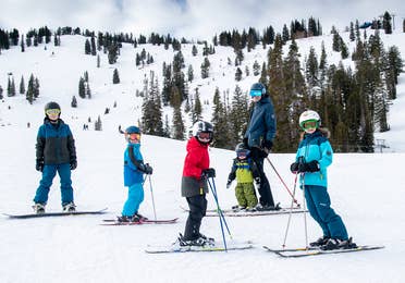 Featured Contributor, Jessica Averett's family, adorn with ski gear, make their way down the snowy slopes.