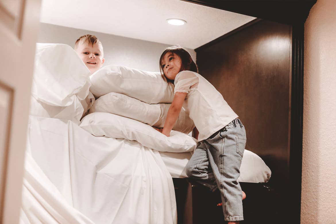 Featured contributor, Mia St. Clair's daughter and nephew make a pillow fort in the bunk bed in their villa at Orange Lake Resort in Orlando, FL.